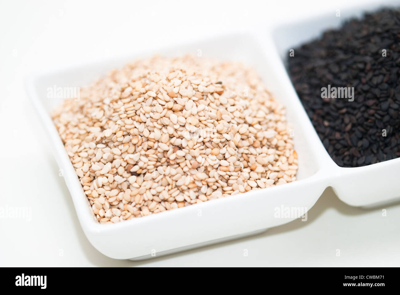 black and white sesame seed in white bowl Stock Photo Alamy