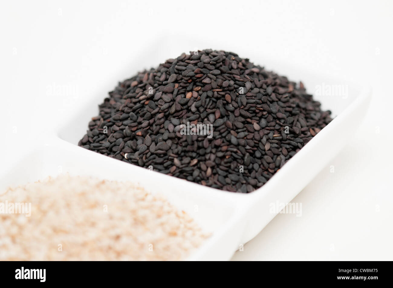 black and white sesame seed in white bowl Stock Photo Alamy