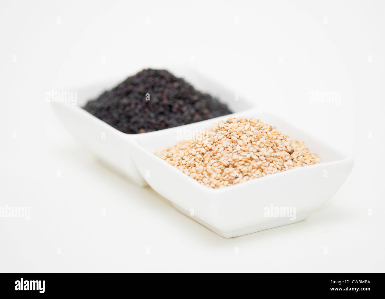 black and white sesame seed in white bowl Stock Photo Alamy