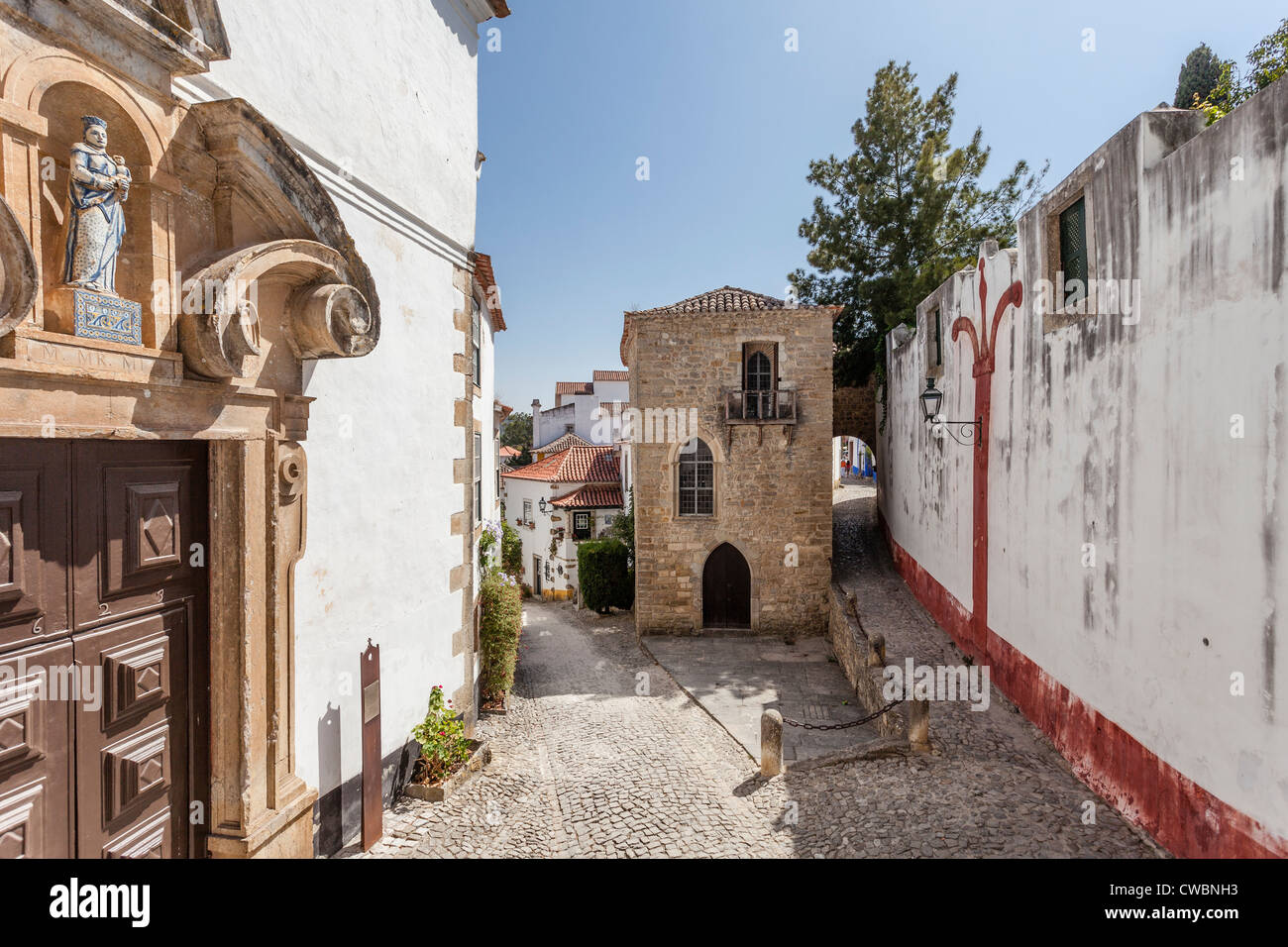 Medieval Synagogue (back) and Misericordia Church Portal (16th century - Renaissance/Mannerist) in Óbidos, Portugal. Stock Photo