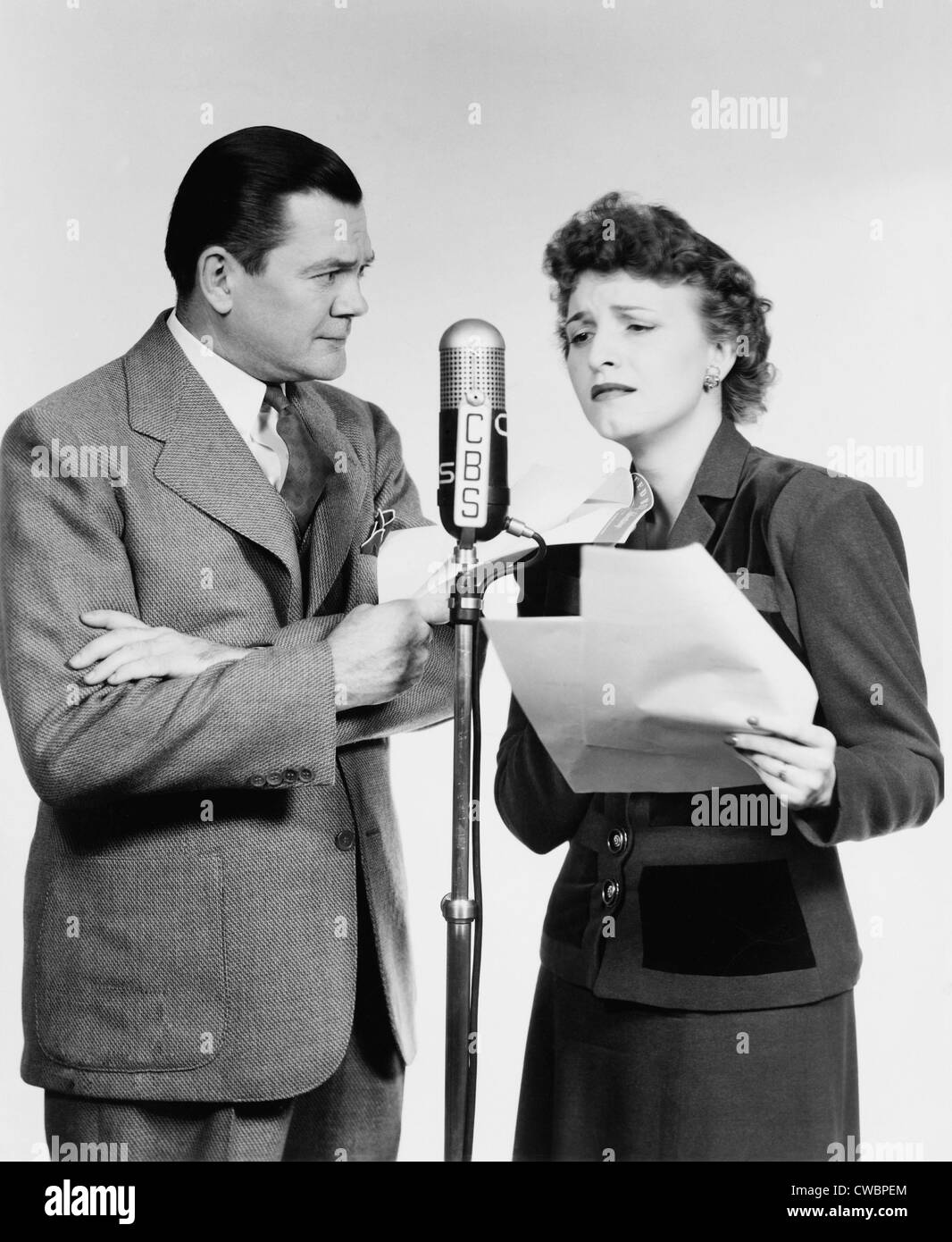 Voice actors Marjorie Hannan and Hugh Studebaker (1900-1973) performing at C.B.S. Radio microphone for the radio show Stock Photo