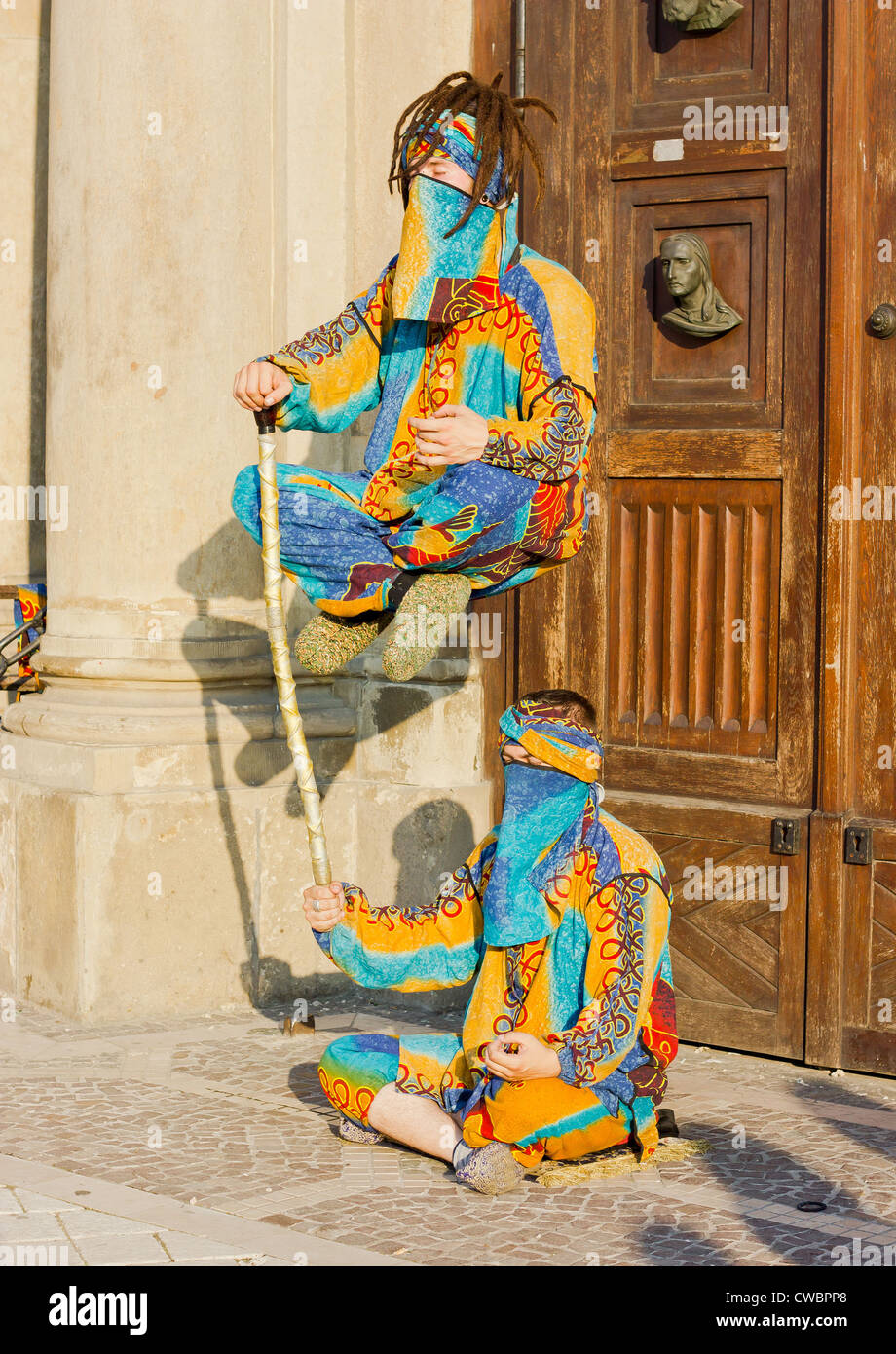 Two street performers performing a floating trick Stock Photo Alamy