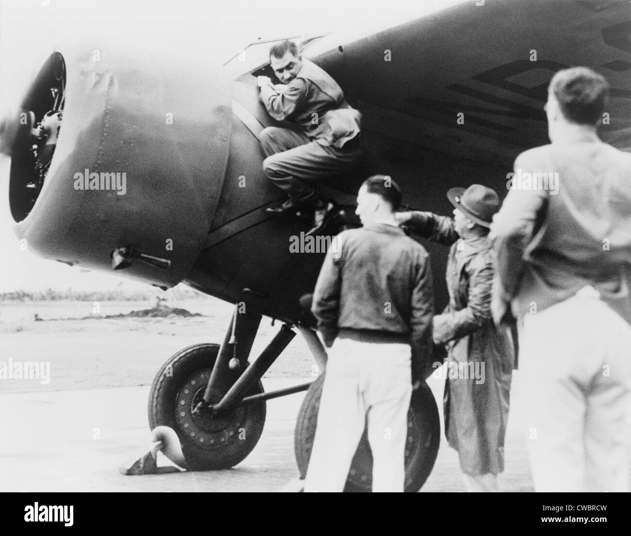 Paul Mantz, stunt pilot and air racer, served as Amelia Earhart's technician for her Hawaii to Oakland flight, climbing down Stock Photo