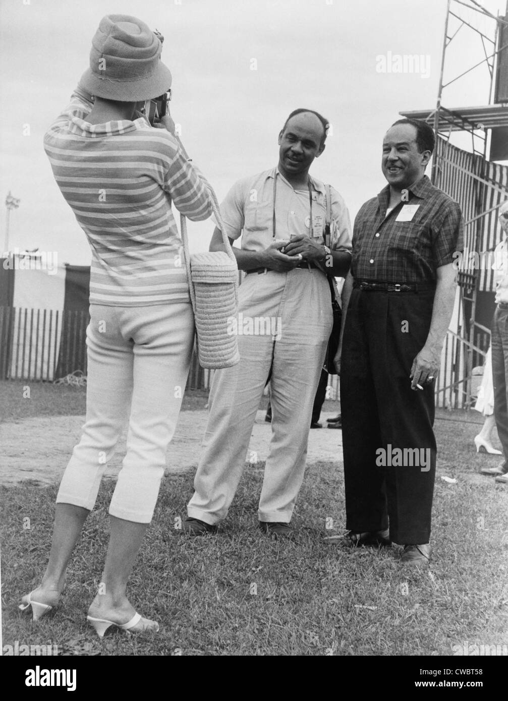 Ralph Ellison and Langston Hughes, famous African American authors, pose for an admirer's photo at the Newport Jazz Festival. Stock Photo