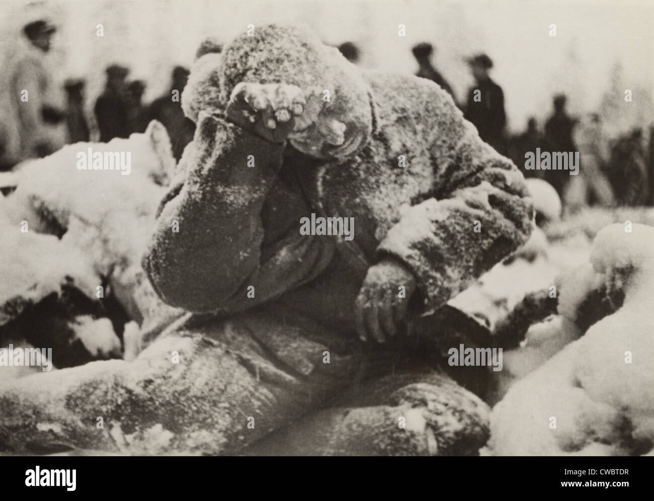 Dead Russian soldier sitting, covered with a dusting of snow, a casualty of the Battle of Suomussalmi, during the Russo-Finnish Stock Photo