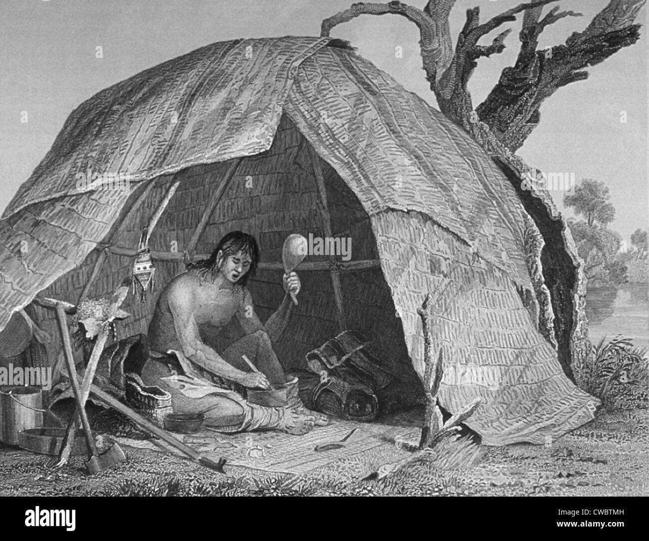 'Indian Doctor Concocting a Pot of Medicine,' by Seth Eastman, shows a medicine-man is sitting in a wigwam preparing medicine Stock Photo