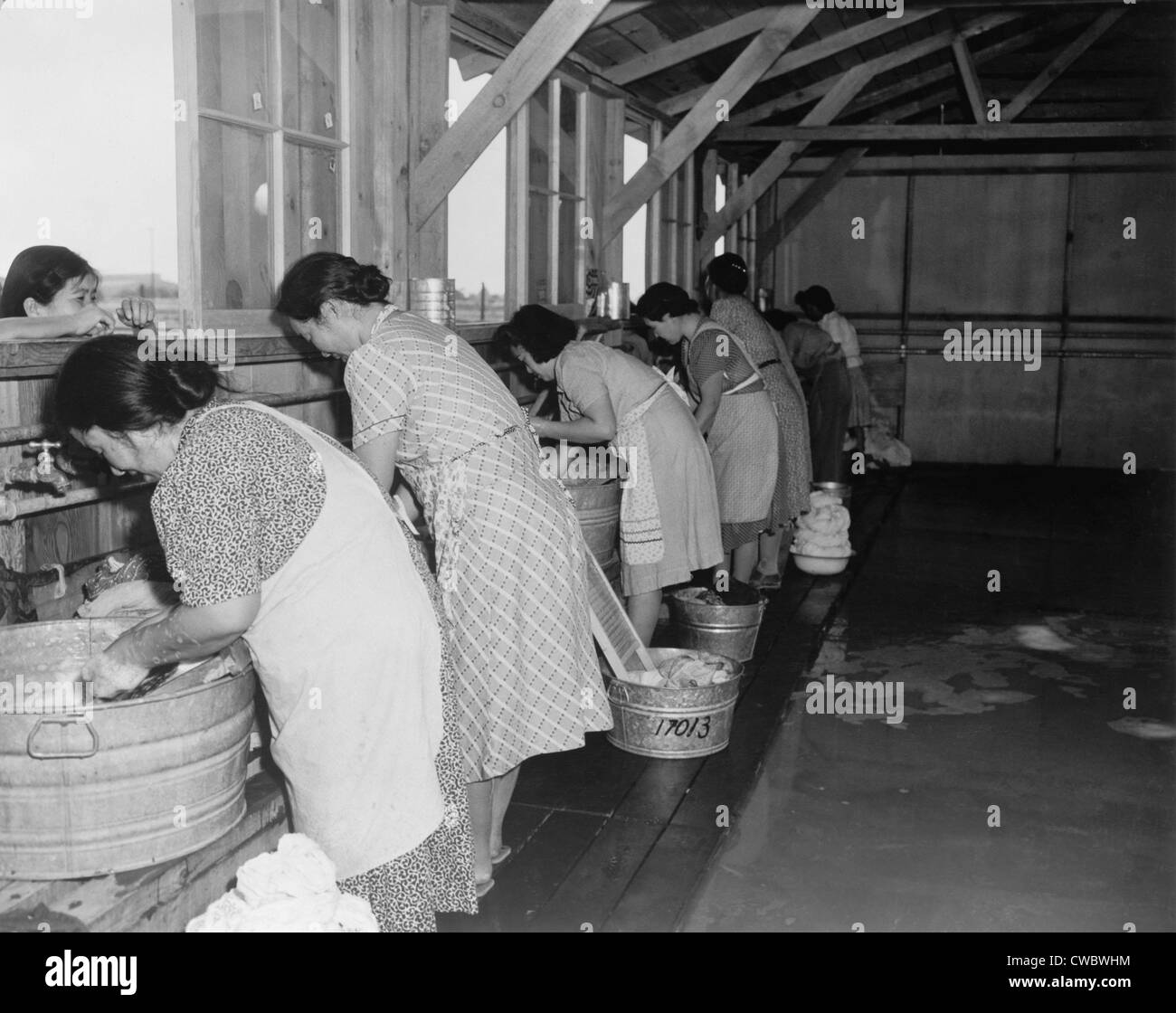 Japanese American women, laundering their families' clothes in metal washtubs during their three month incarceration at Stock Photo