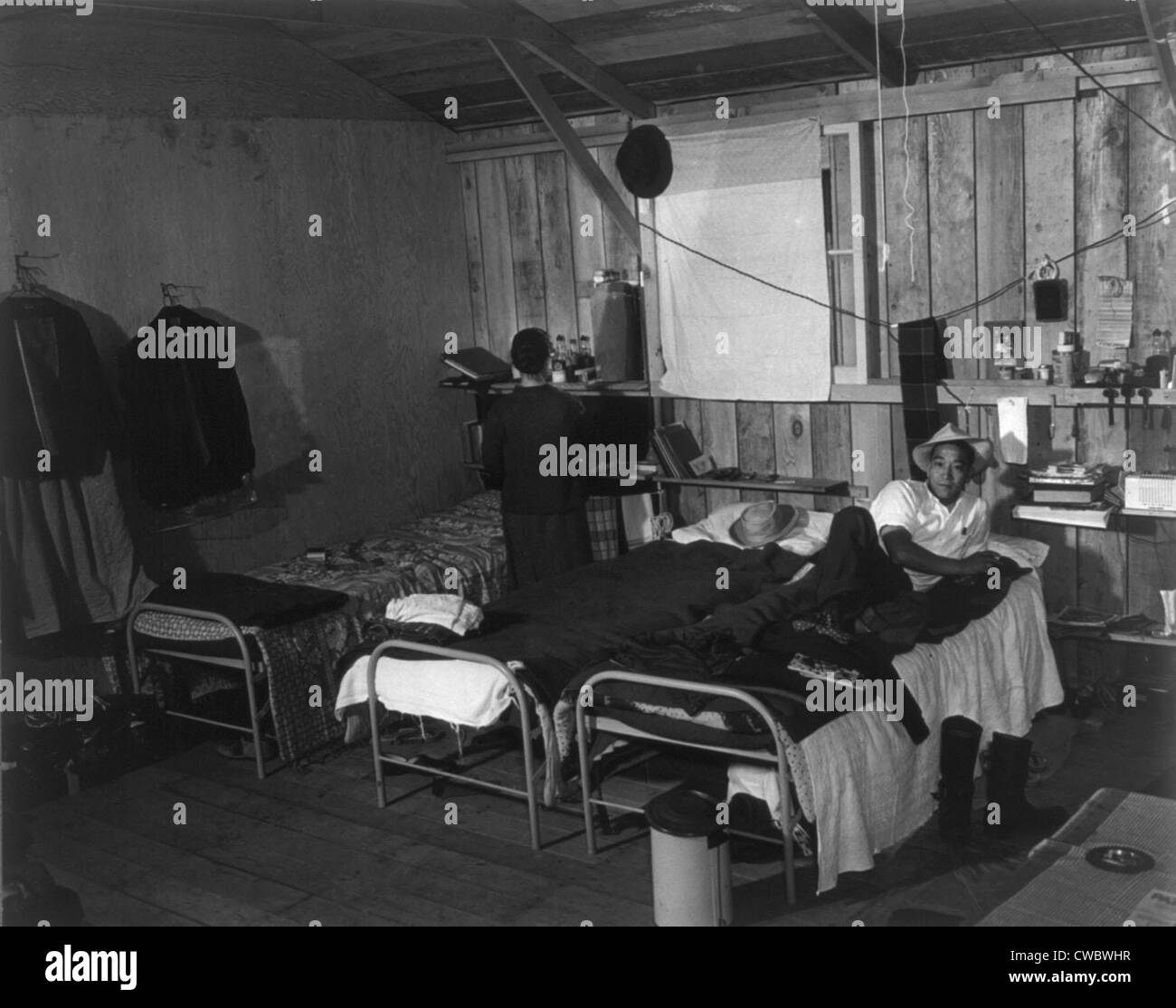 Japanese-American couple in bleak barracks quarters at the Salinas, California assembly center in March 1942. From this initial Stock Photo