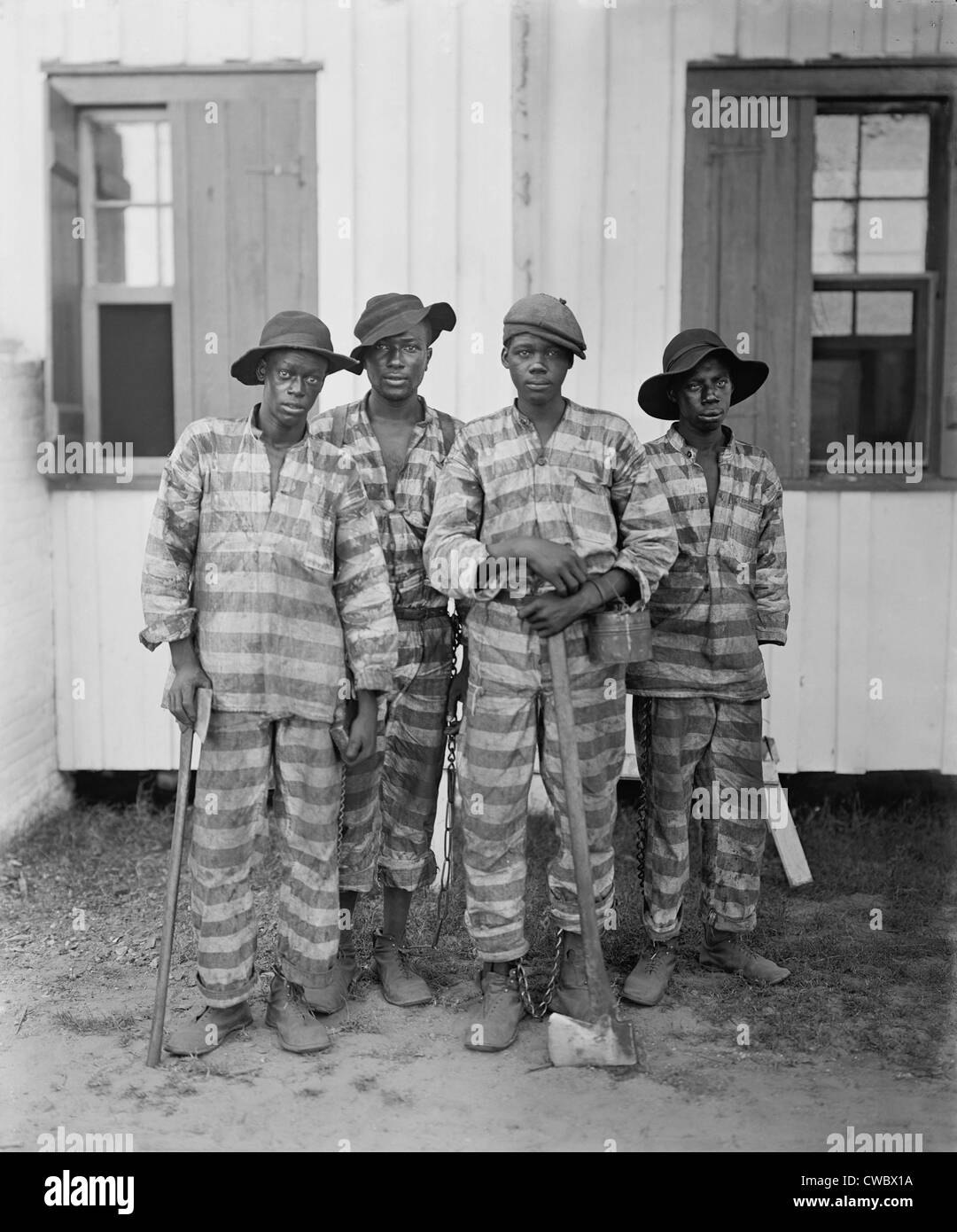 Four African American youths in a Southern chain gang. Southern jails made money leasing convicts for forced labor in the Jim Stock Photo