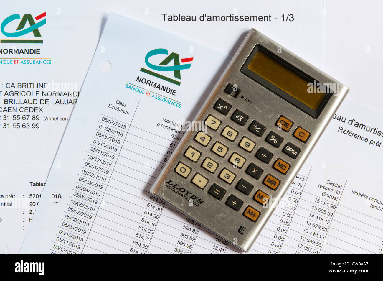 A pocket calculator laying on a mortgage repayment schedule. Stock Photo
