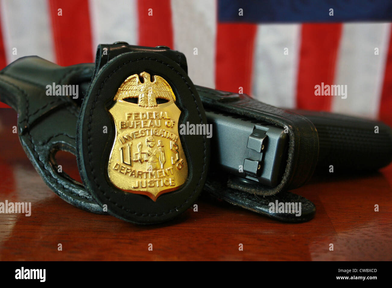 Contemporary FBI badge and gun with American flag. Stock Photo
