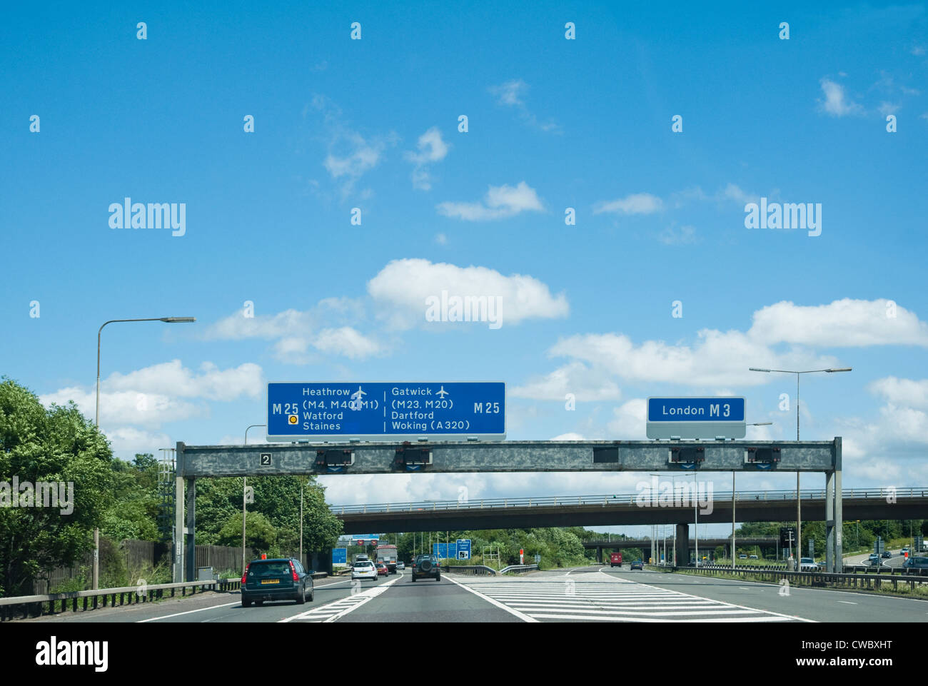 M25 Motorway signs - with separating lanes for either Heathrow and Gatwick Airports to the left - or London M3 to the right. UK Stock Photo