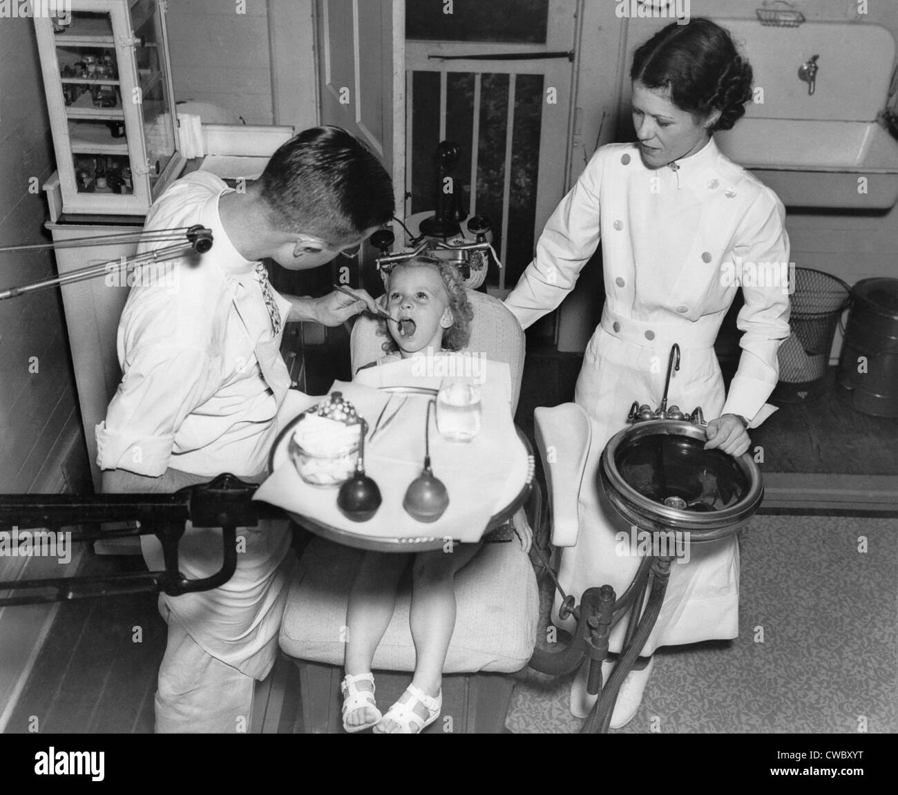 A dentist examining a young girl's teeth in 1942. Stock Photo
