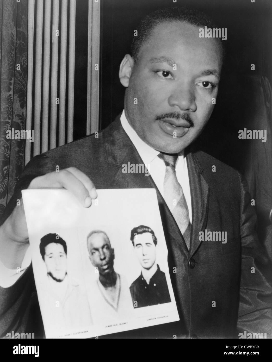 Dr. Martin Luther King (1929-1968), holding photographs of three civil rights workers who were murdered by the Ku Klux Klan: Stock Photo
