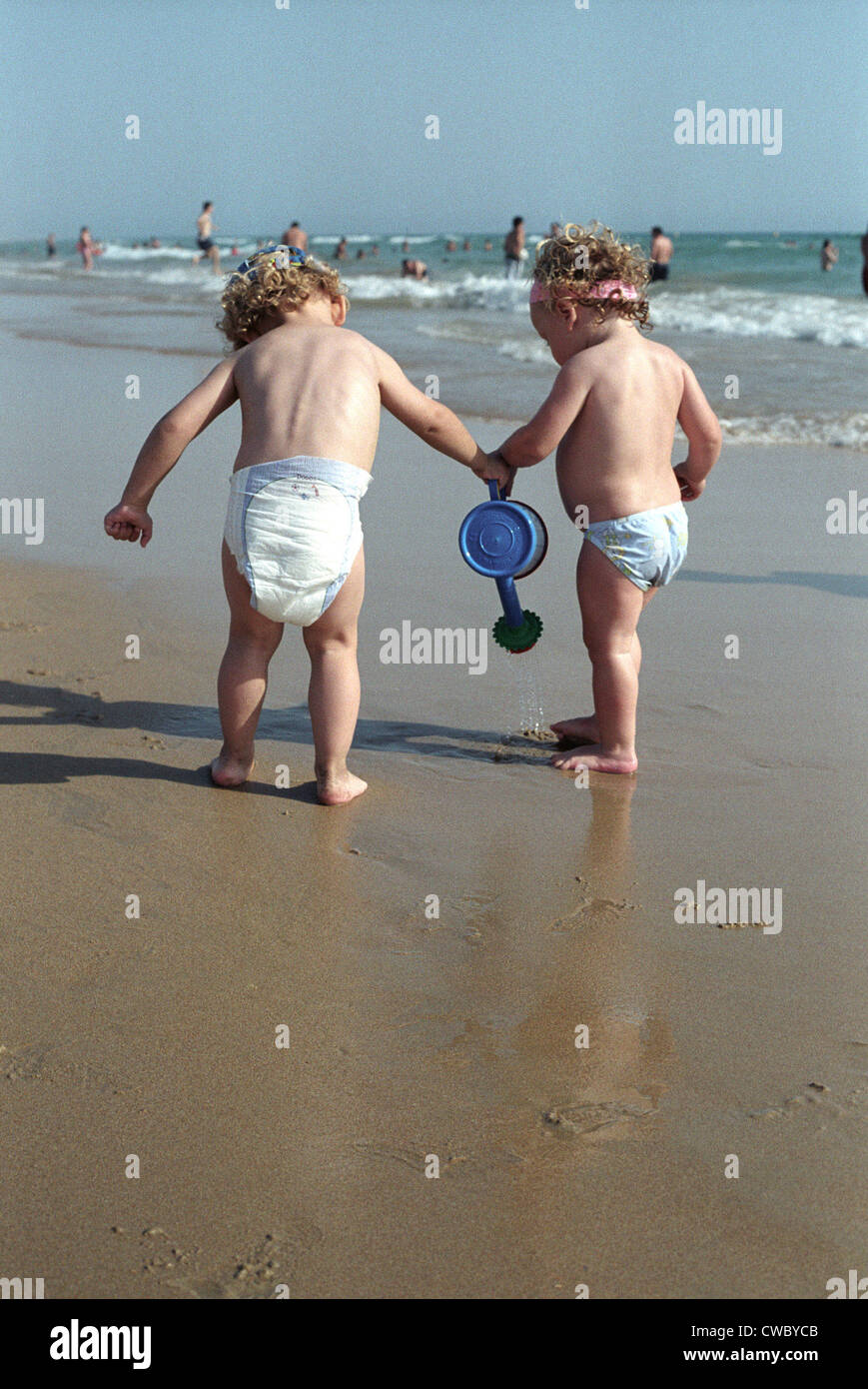Little boy and little girl playing together on beach Stock Photo