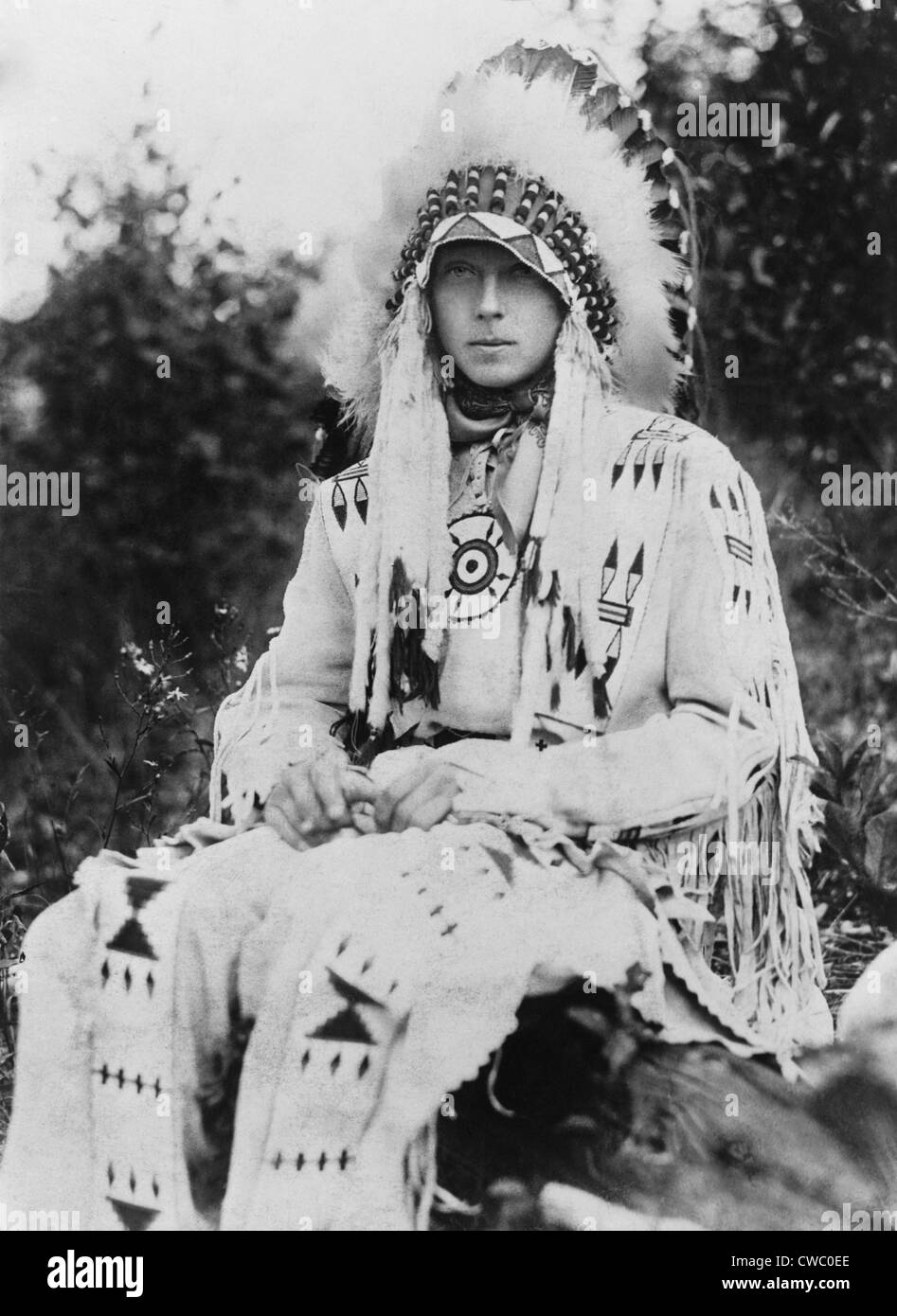 Britain's King Edward VIII as Prince of Wales, wearing the headdress of a Native American chief during a visit to the United Stock Photo