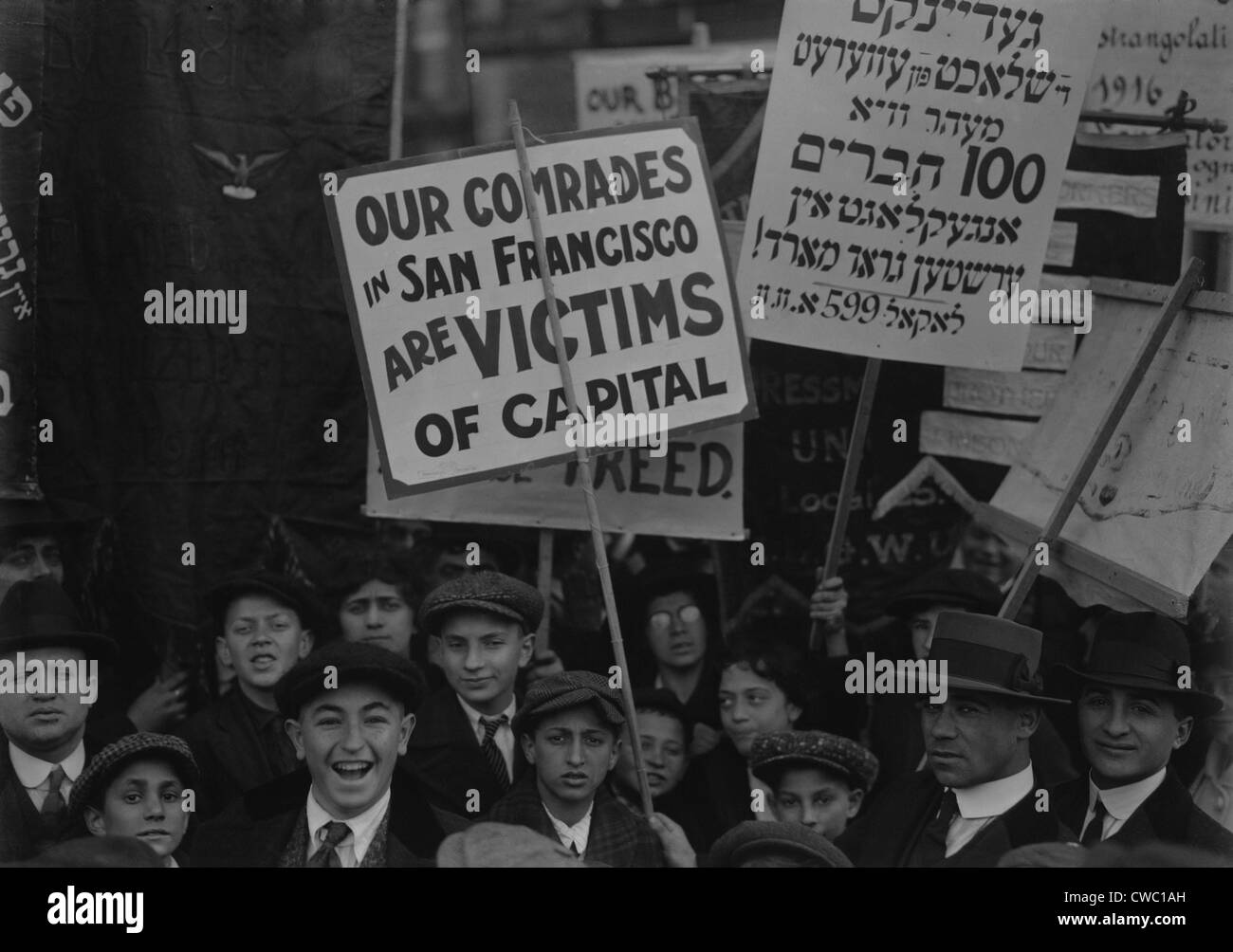 OUR COMRADES IN SAN FRANCISCO ARE VICTIMS OF CAPITAL, reads a sign in a