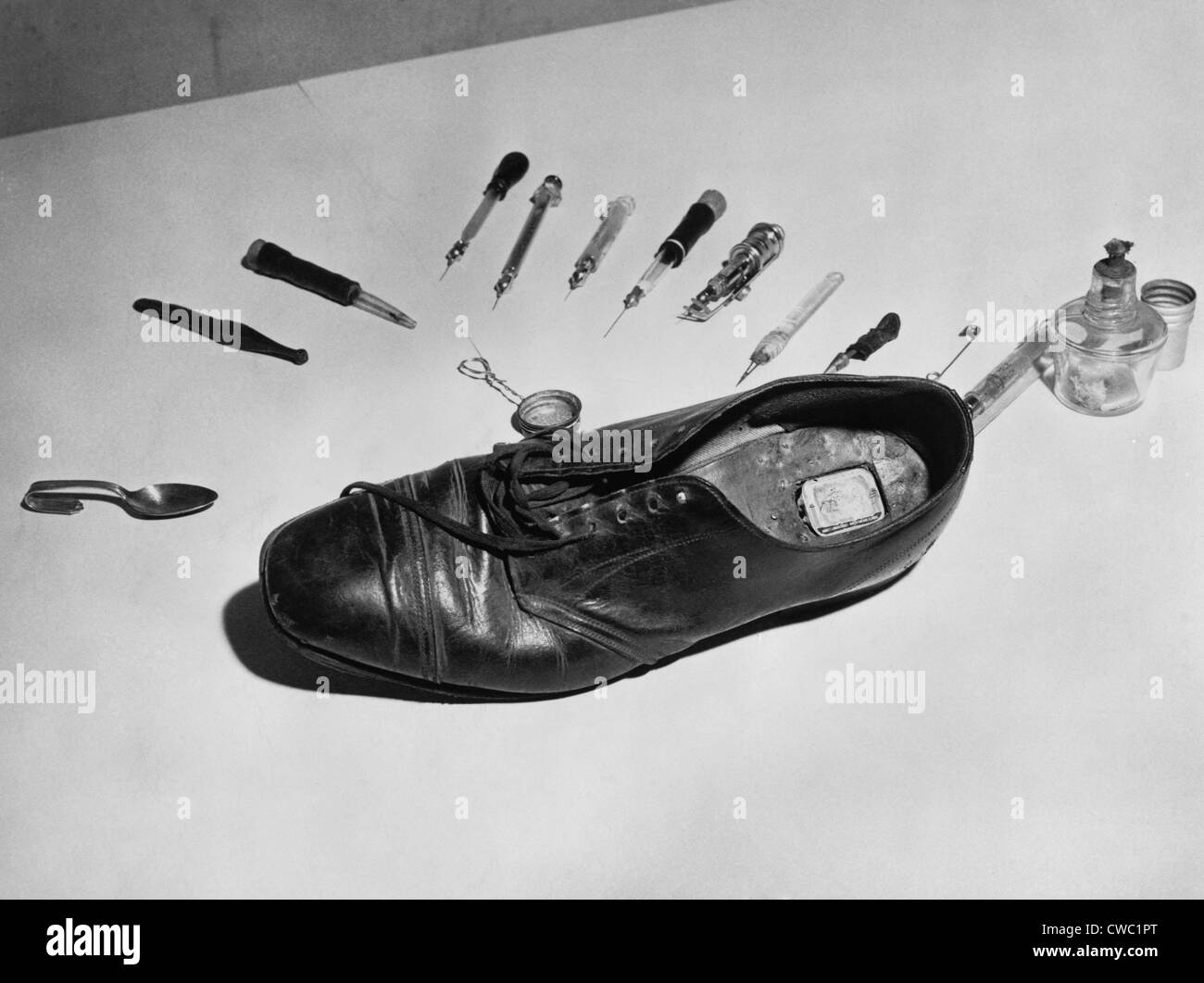Law enforcement photo of a shoe with metal box in cut out section of heel used to smuggle drugs into a detention facility. For Stock Photo