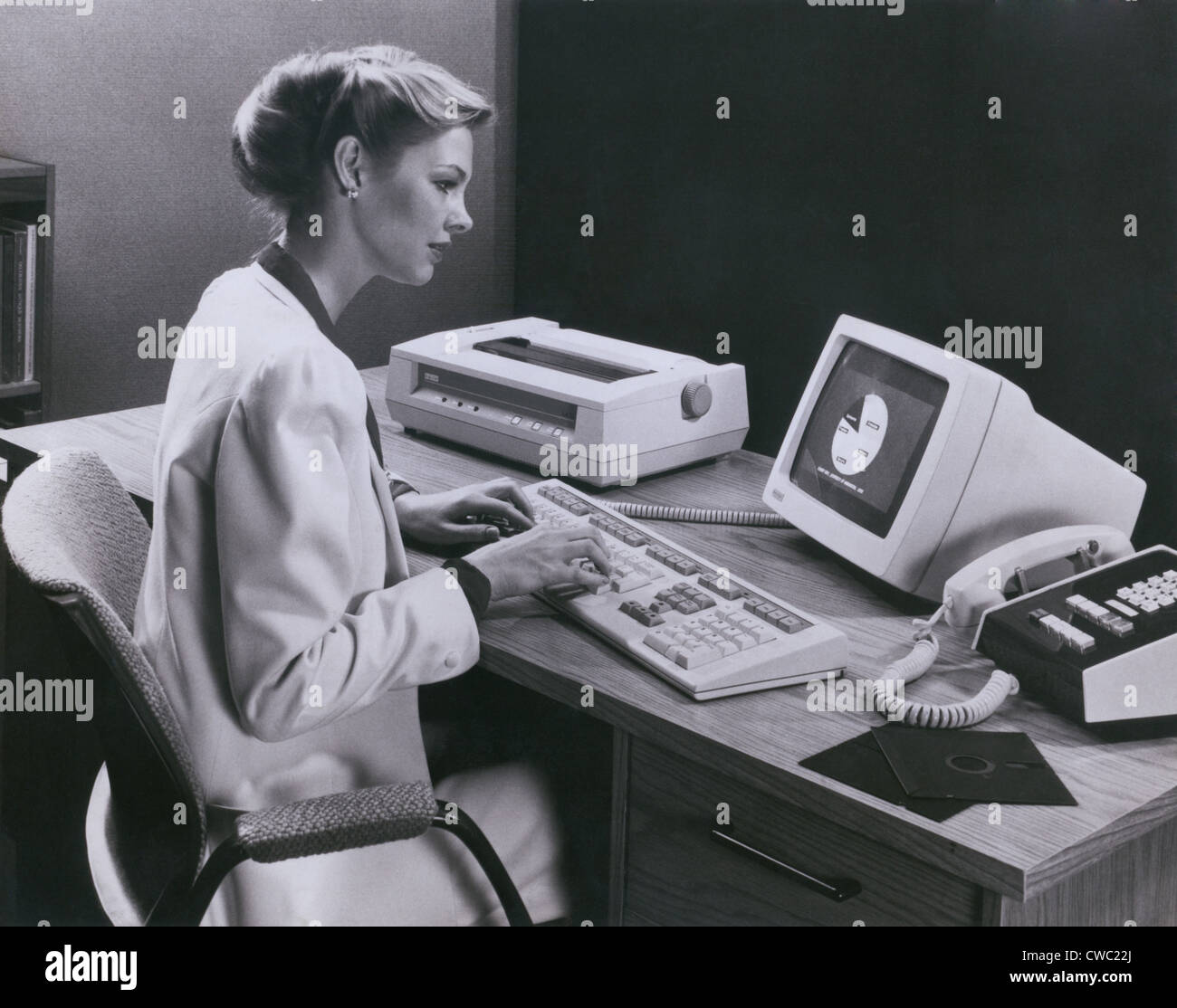 Women using and early personal computer made by the Digital Equipment Corporation of Maynard Massachusetts in 1982. The Stock Photo