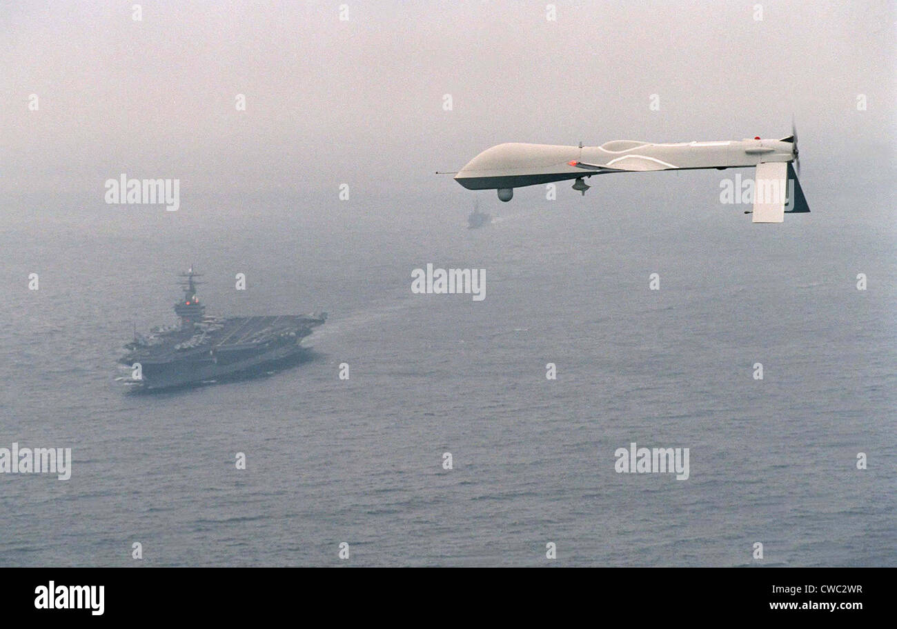 Predator Unmanned Aerial Vehicle flies above the aircraft carrier USS Carl Vinson on a Navy aerial reconnaissance test flight Stock Photo