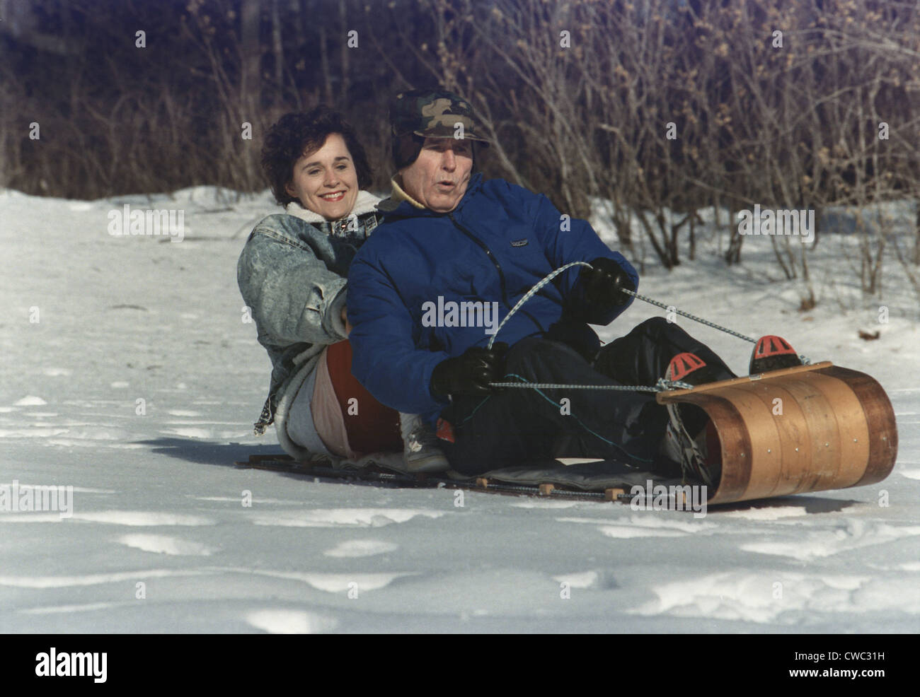 President George Bush goes sledding at Camp David with his daughter Doro. Jan. 13 1991. (BSLOC 2011 3 67) Stock Photo