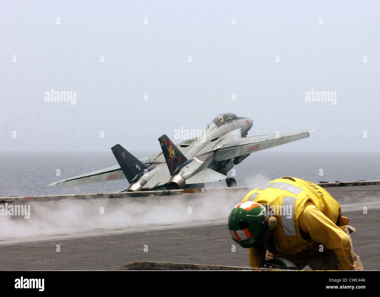 F-14 Tomcat fighter launches from the flight deck of the aircraft carrier USS John F. Kennedy on a combat missions over Stock Photo