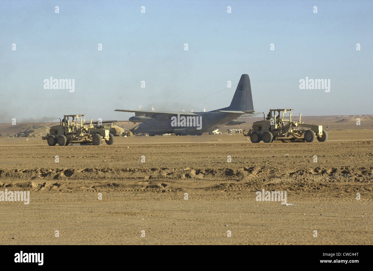 U.S. Navy Seabees run heavy graders down the runway to patch holes and remove excess dirt in the first weeks' occupation of Stock Photo