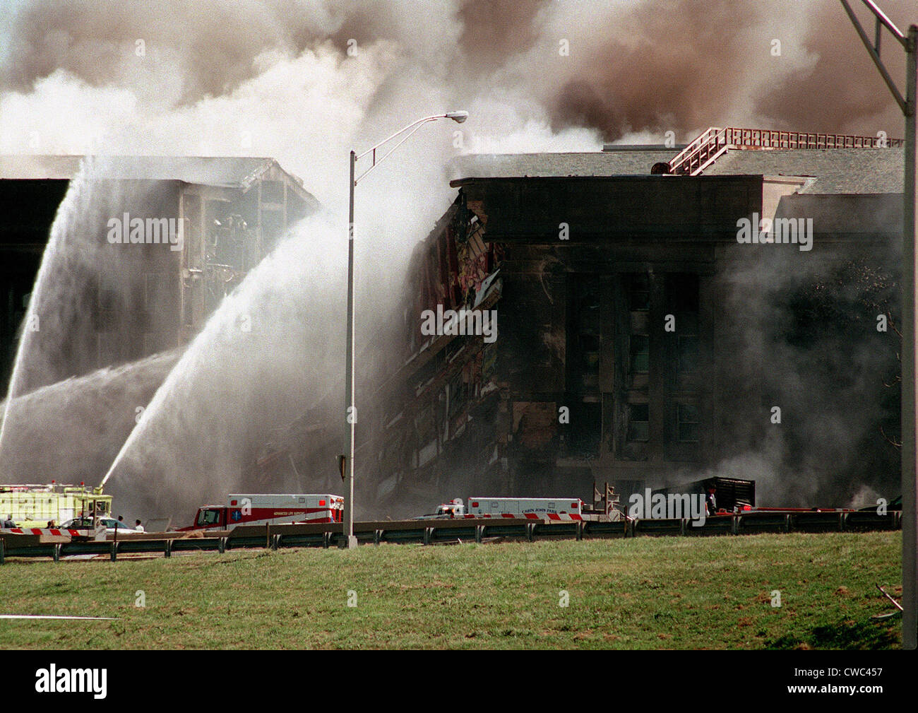 Firefighters struggle to contain the fire after the September 11 2001 terrorist attack on the Pentagon. 64 passengers of Stock Photo