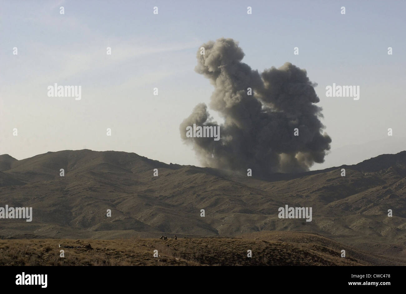 An enemy position in Afghanistan's Gardez Valley is destroyed by smart bombs dropped by B-52 bombers attacking al-Qaeda and Stock Photo