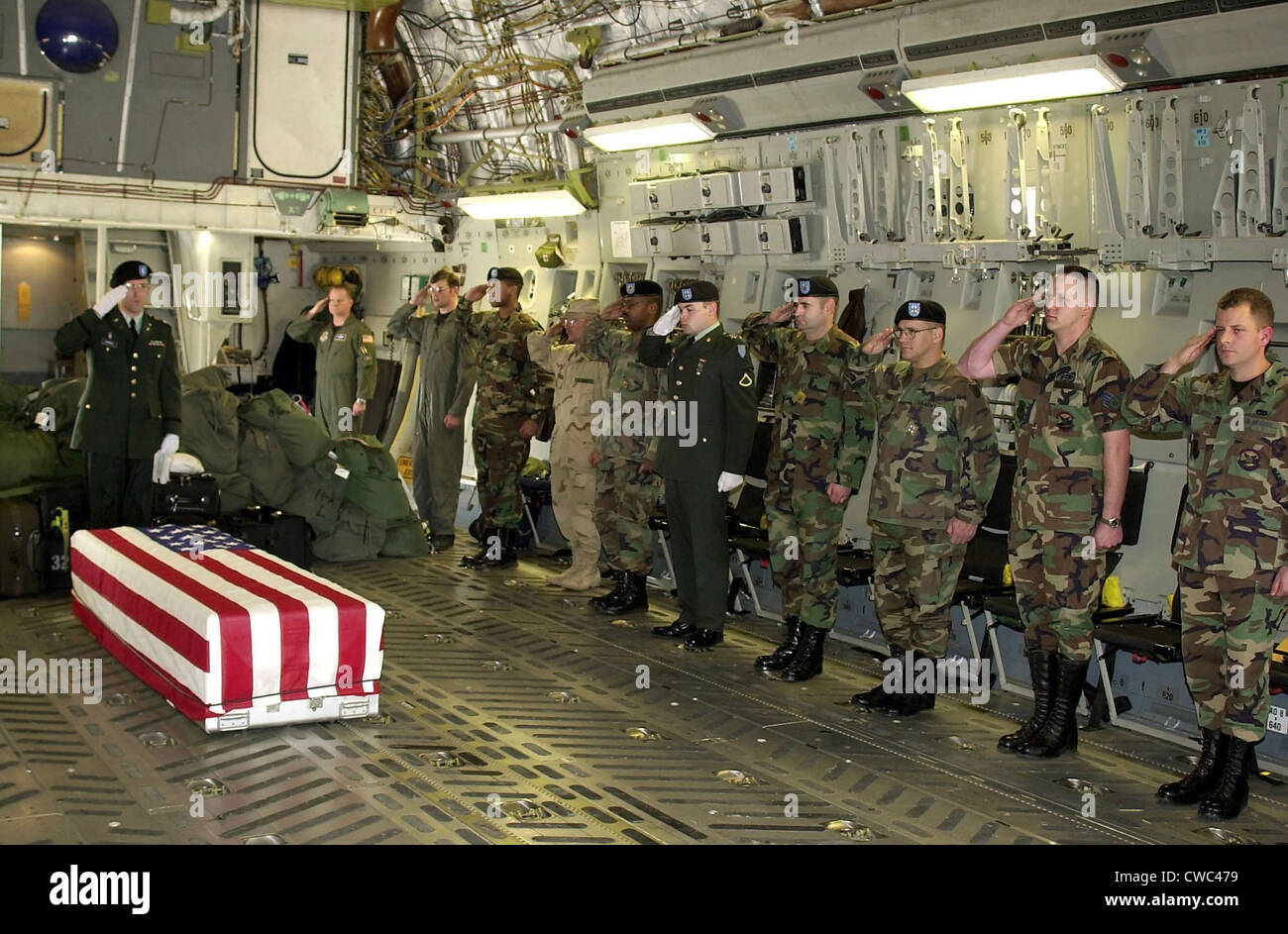 U.S. Military personnel salute the flag draped coffin Chief Petty Officer Matthew J. Bourgeois during his Fallen Soldier Stock Photo