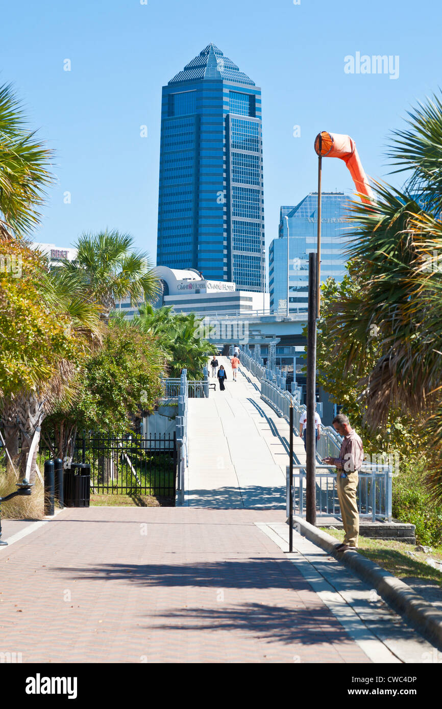 Joggers and walkers on the Northbank Riverwalk pedestrian bridge near