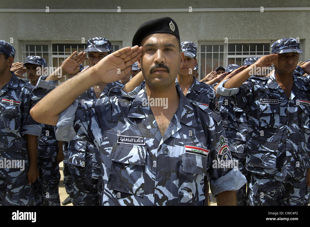 Graduates of the Iraqi Police Academy's salute during the commencement ceremony in Salman Pak Iraq. Aug. 29 2008. Stock Photo