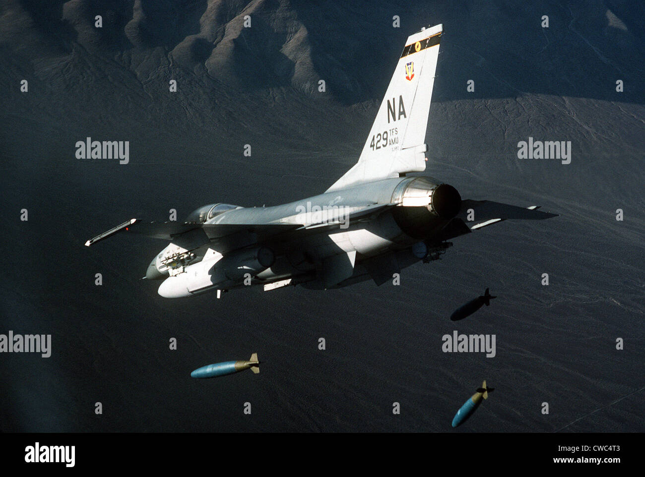F-16 Fighter releasing three 2000-pound bombs. Feb 1 1987. (BSLOC 2011 12 220) Stock Photo