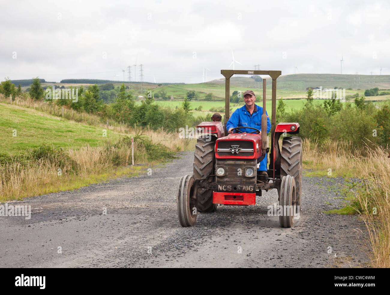 Enthusiast driving a vintage Massey Ferguson 135 tractor during an Ayrshire Vintage Tractor and Machine Club road run Stock Photo