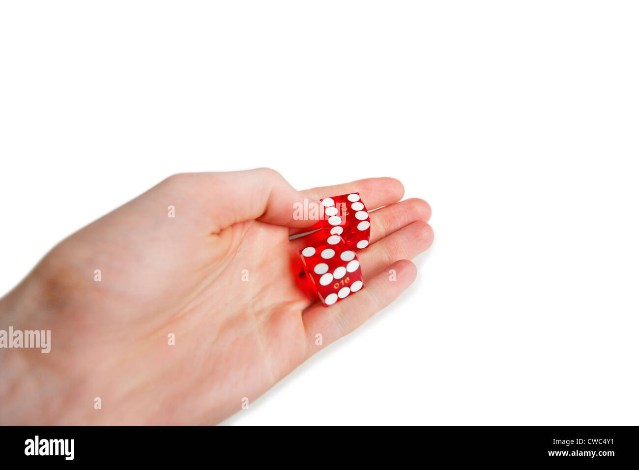 Cropped image of hands holding gambling cubes over white background Stock Photo