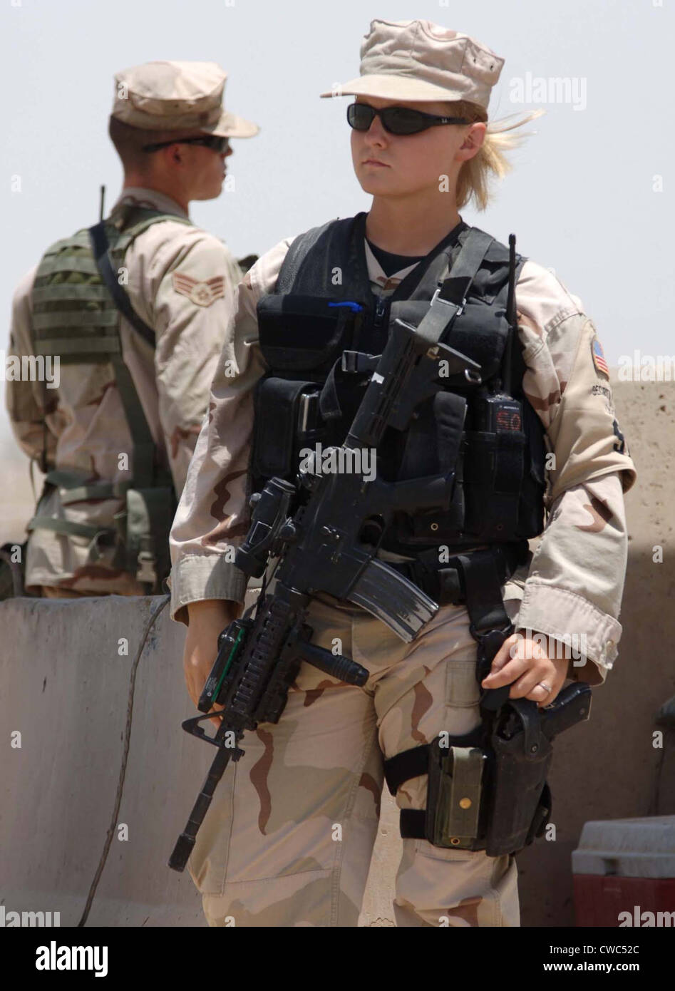 Two US Airman stand watch at Sather Air Base in Iraq. One is female in combat gear. Ca. 2008. (BSLOC 2011 12 368) Stock Photo