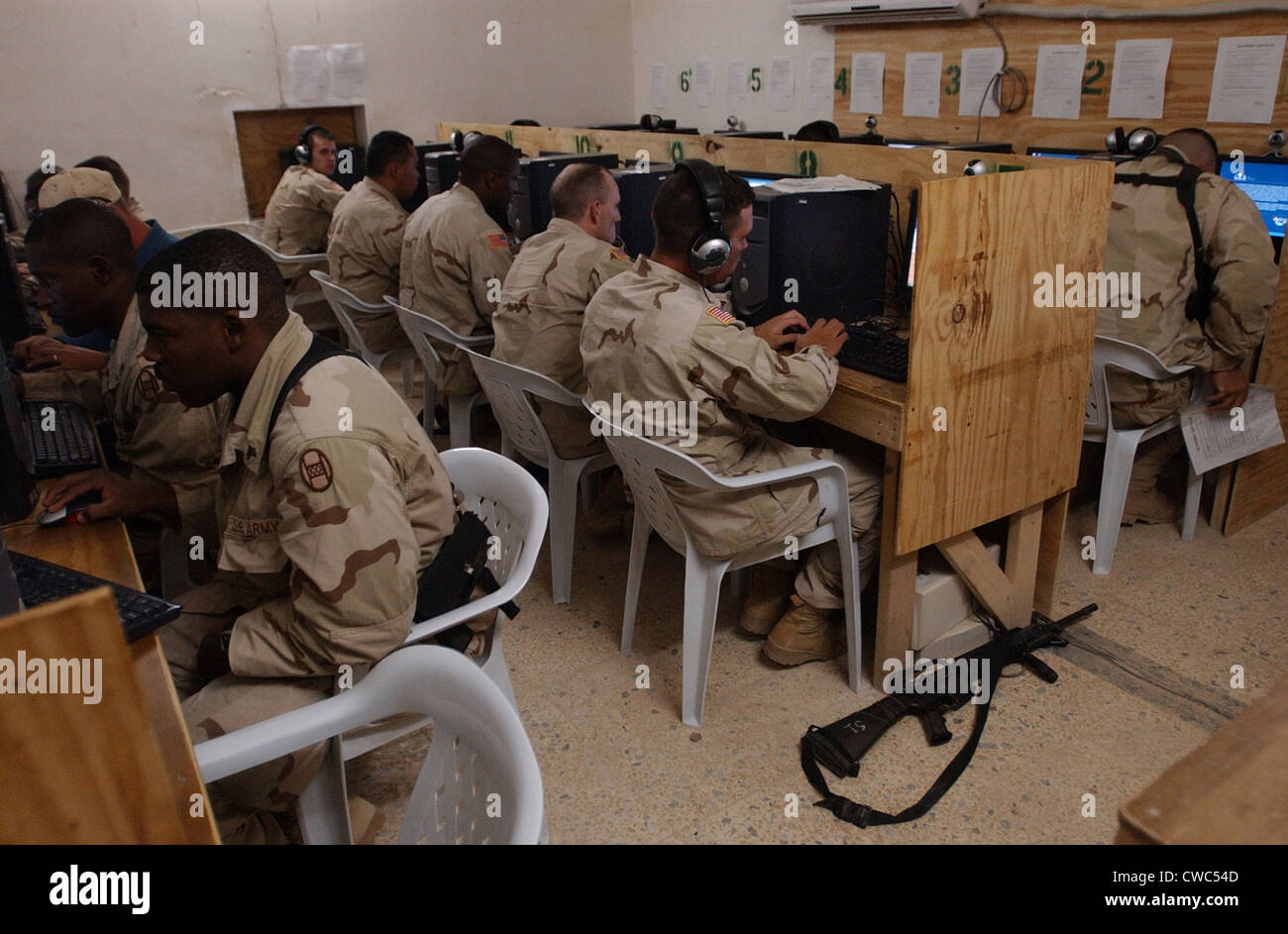 US Army soldiers e-mail their families before eating Thanksgiving dinner at Camp Cobra in Iraq on Nov. 25 2004. Stock Photo
