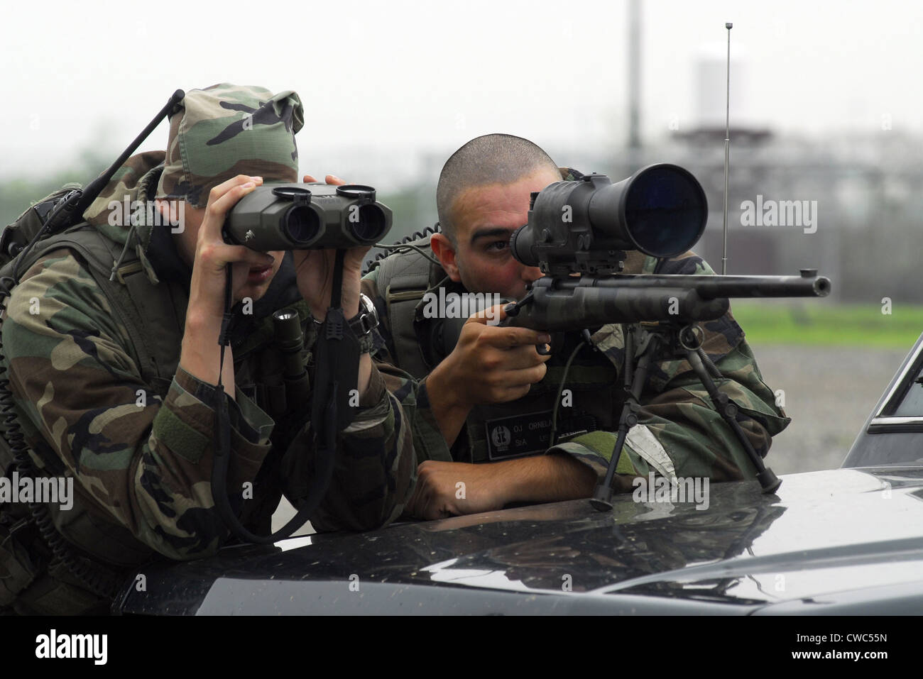 A sniper team search for opposing forces during an exercise at Osan Air Base South Korea July 23 2008. (BSLOC 2011 12 312) Stock Photo