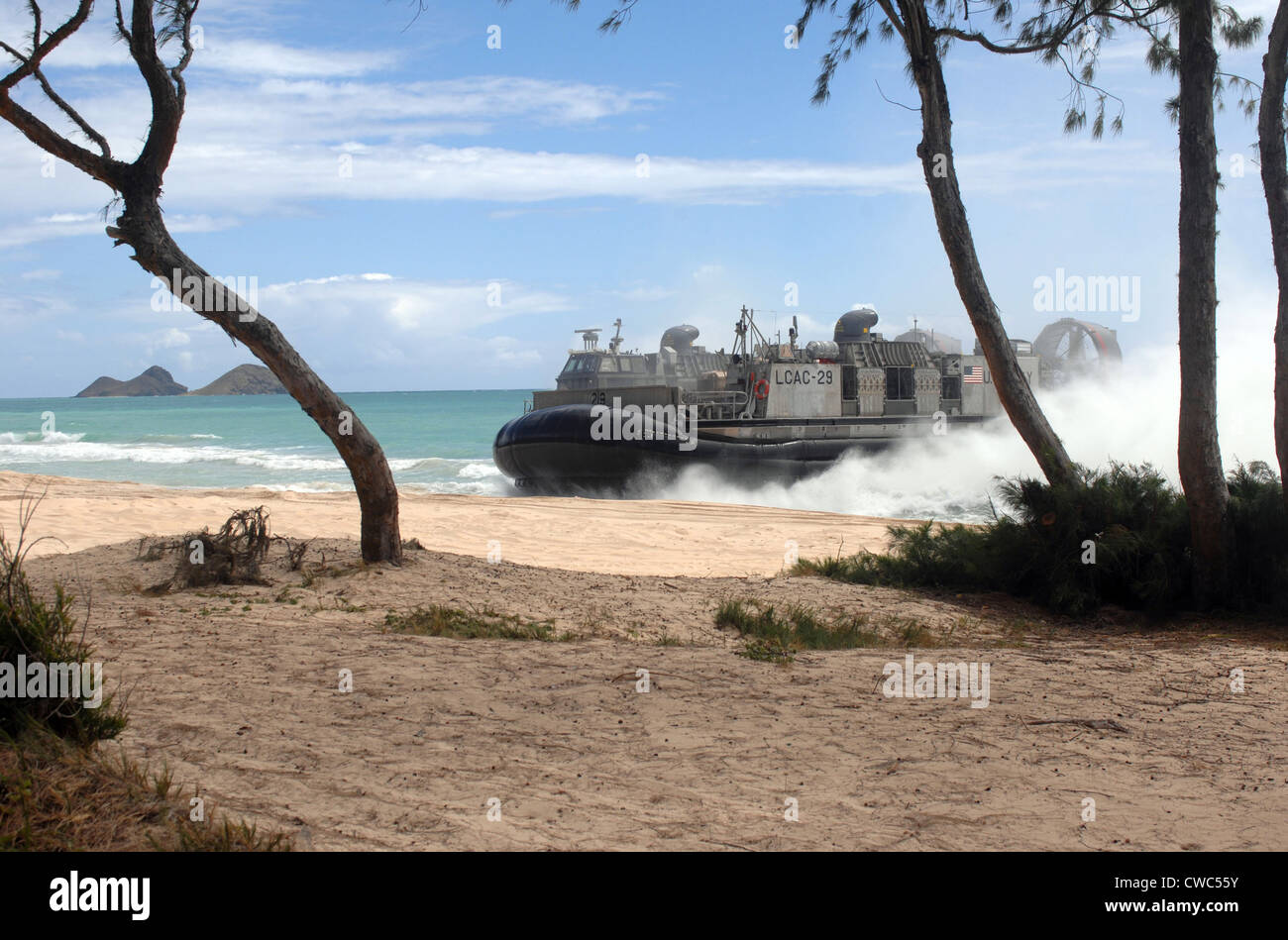High-speed over-the-beach amphibious landing craft approaching a beach on an air cushion that allows a dry beach landing. With Stock Photo
