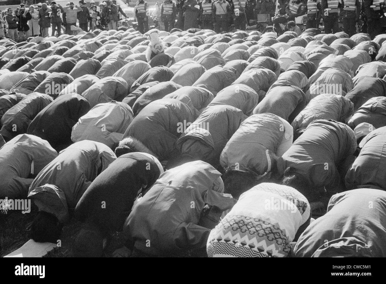 Iranian men kneeling in prayer at an demonstration during the Iran Hostage Crisis in Washington D.C. Nov. 30 1979 Stock Photo