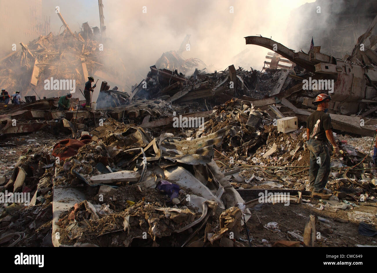 Workers attack the pile of twisted steel and rubble to clear debris from the smoldering wreckage of the World Trade Center two Stock Photo