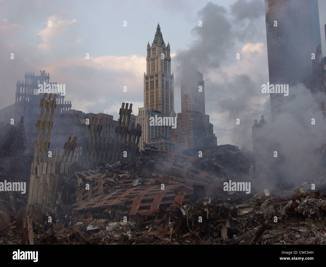 The classic skyscraper the Woolworth Building is seen through smoking remains of the World Trade Center 10 days after the Stock Photo