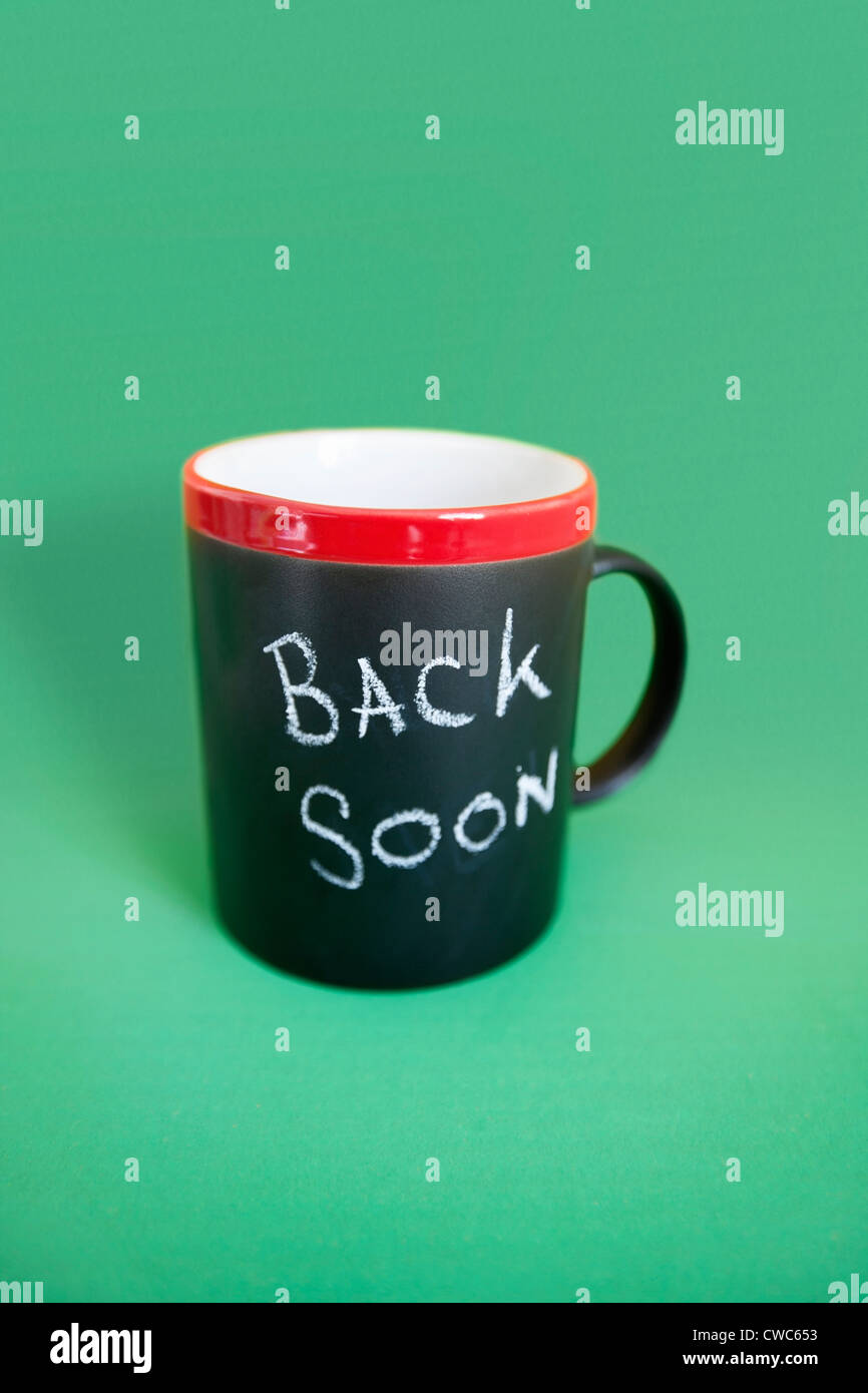 Coffee mug with text over colored background Stock Photo