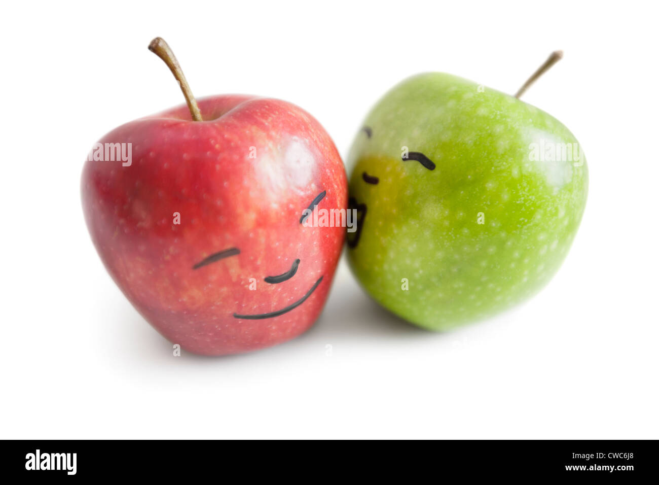 Granny smith apple kissing red apple over white background Stock Photo
