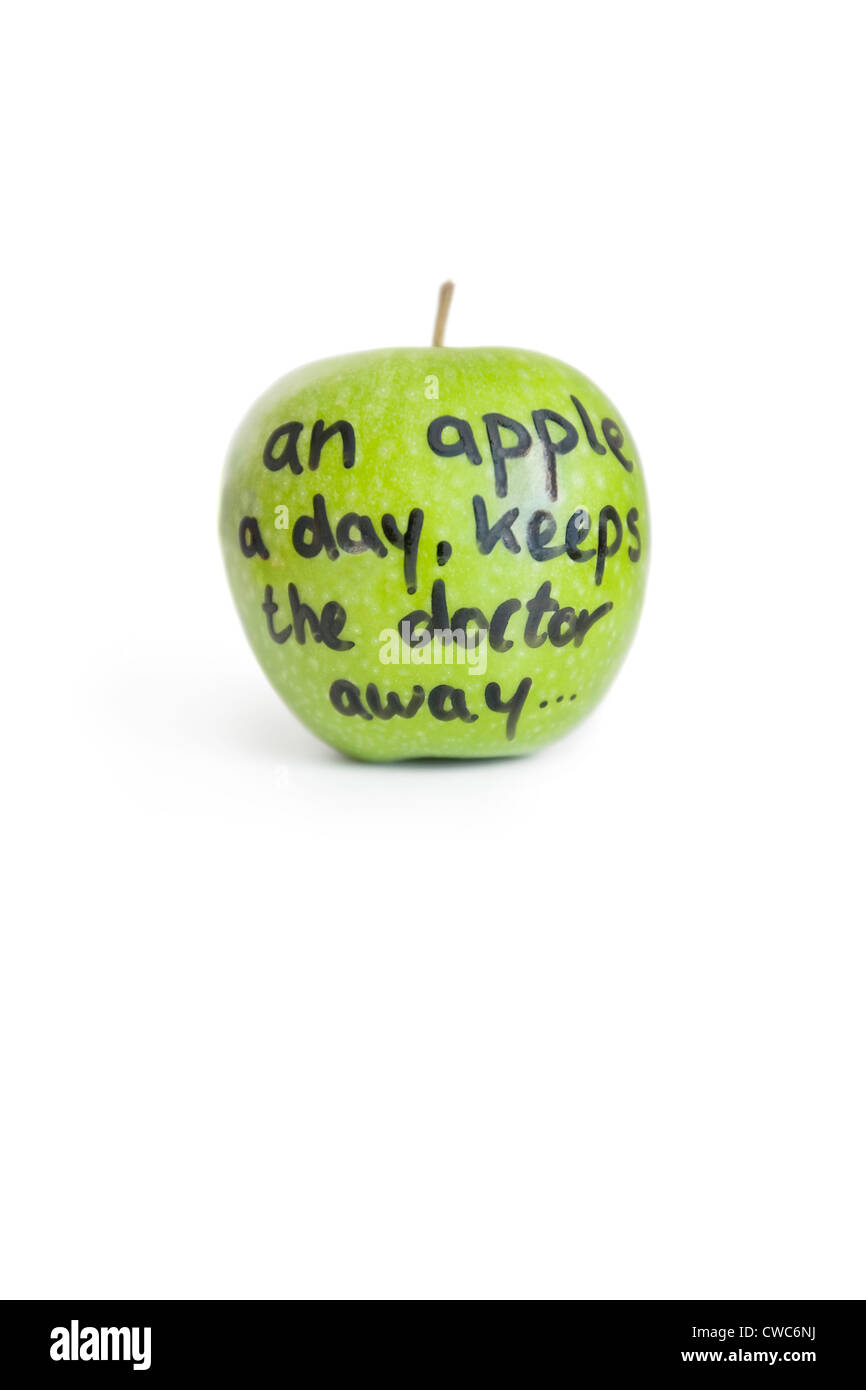 Close-up of sayings text on a juicy granny smith apple over white background Stock Photo