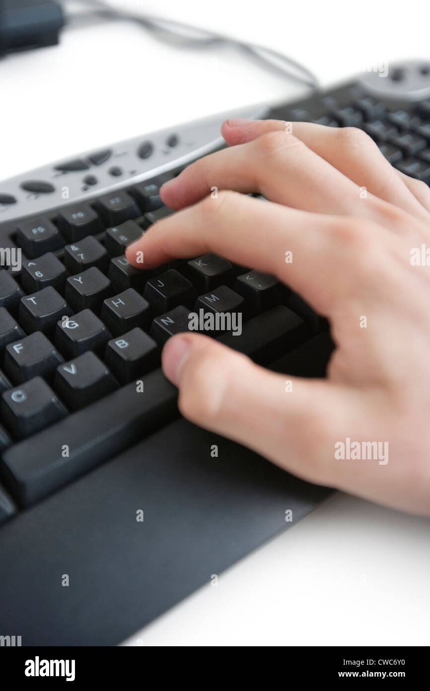 Cropped image of a hand on computer keyboard Stock Photo