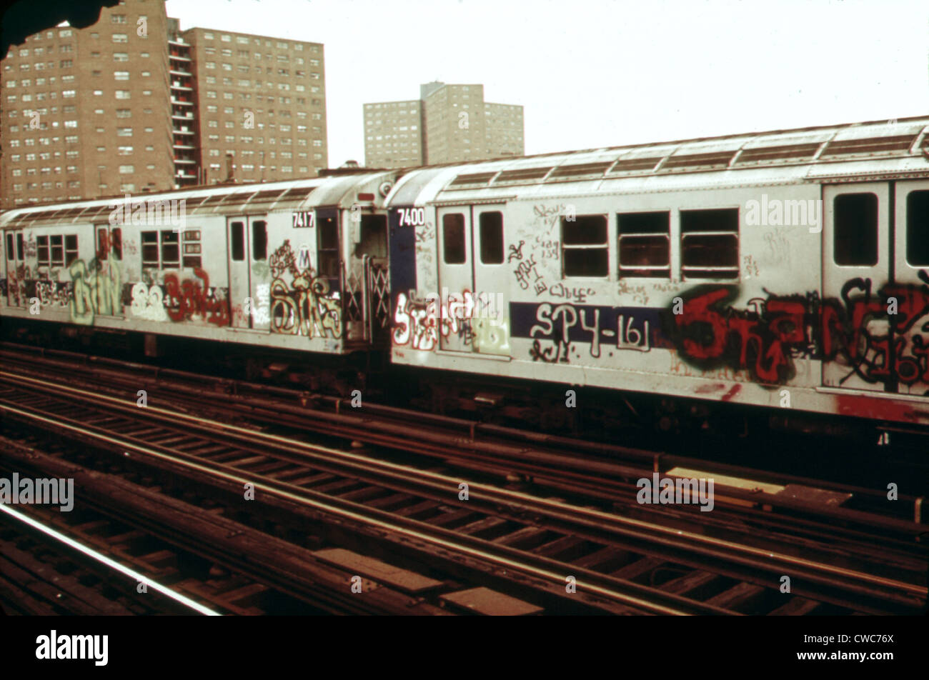 New York City Subway. A graffiti painted subway train with housing projects in the background. Outside of Manhattan many New Stock Photo