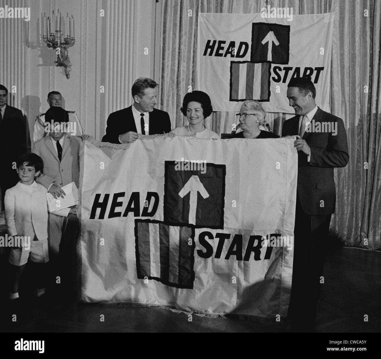 LBJ's Great Society programs. Ceremony for National Head Start program. Holding the sign are actor Danny Kaye, Lady Bird Stock Photo