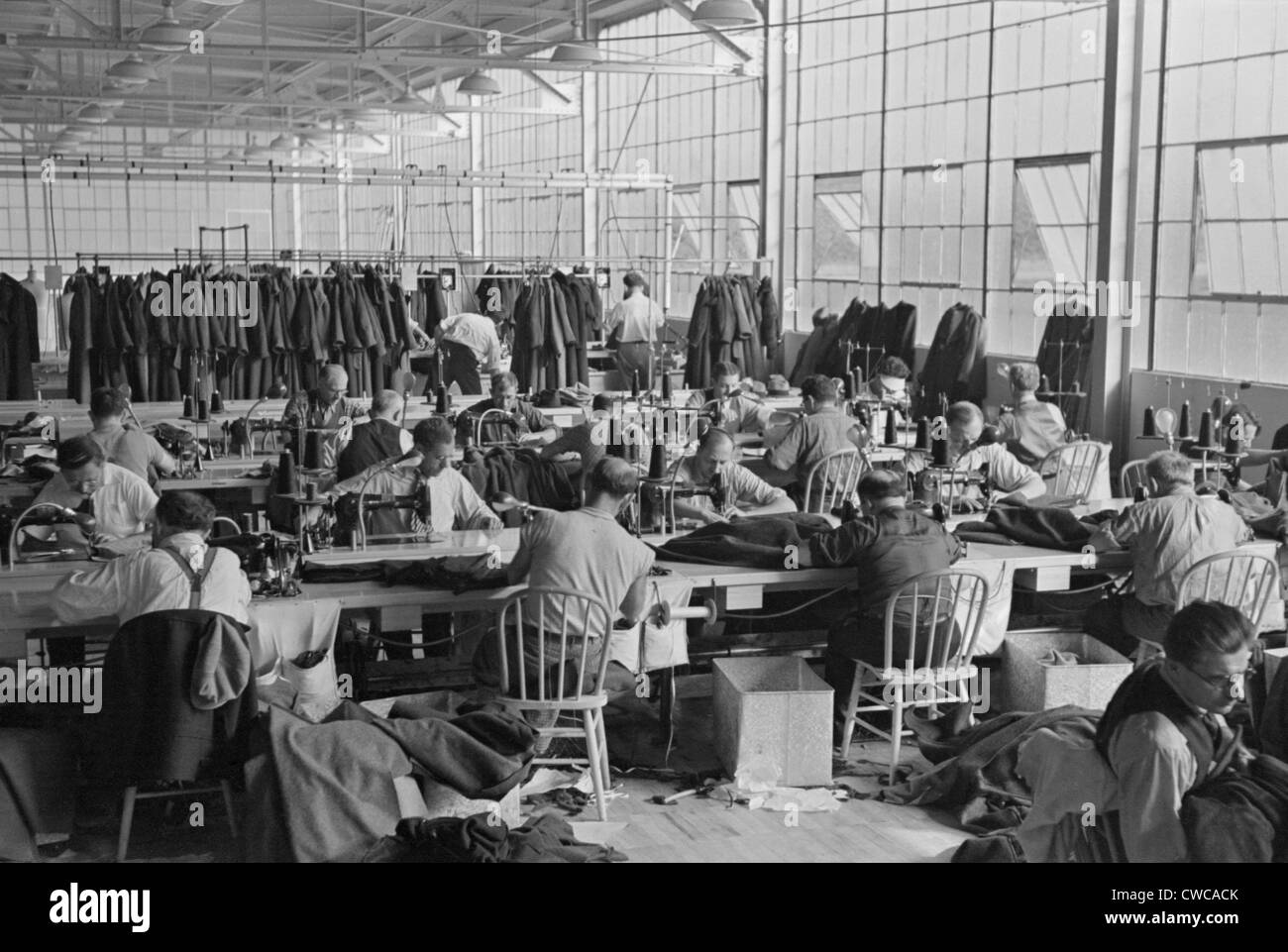 Cooperative garment factory at Jersey Homesteads, showing homesteaders at their work and some of the ladies' coats made by Stock Photo