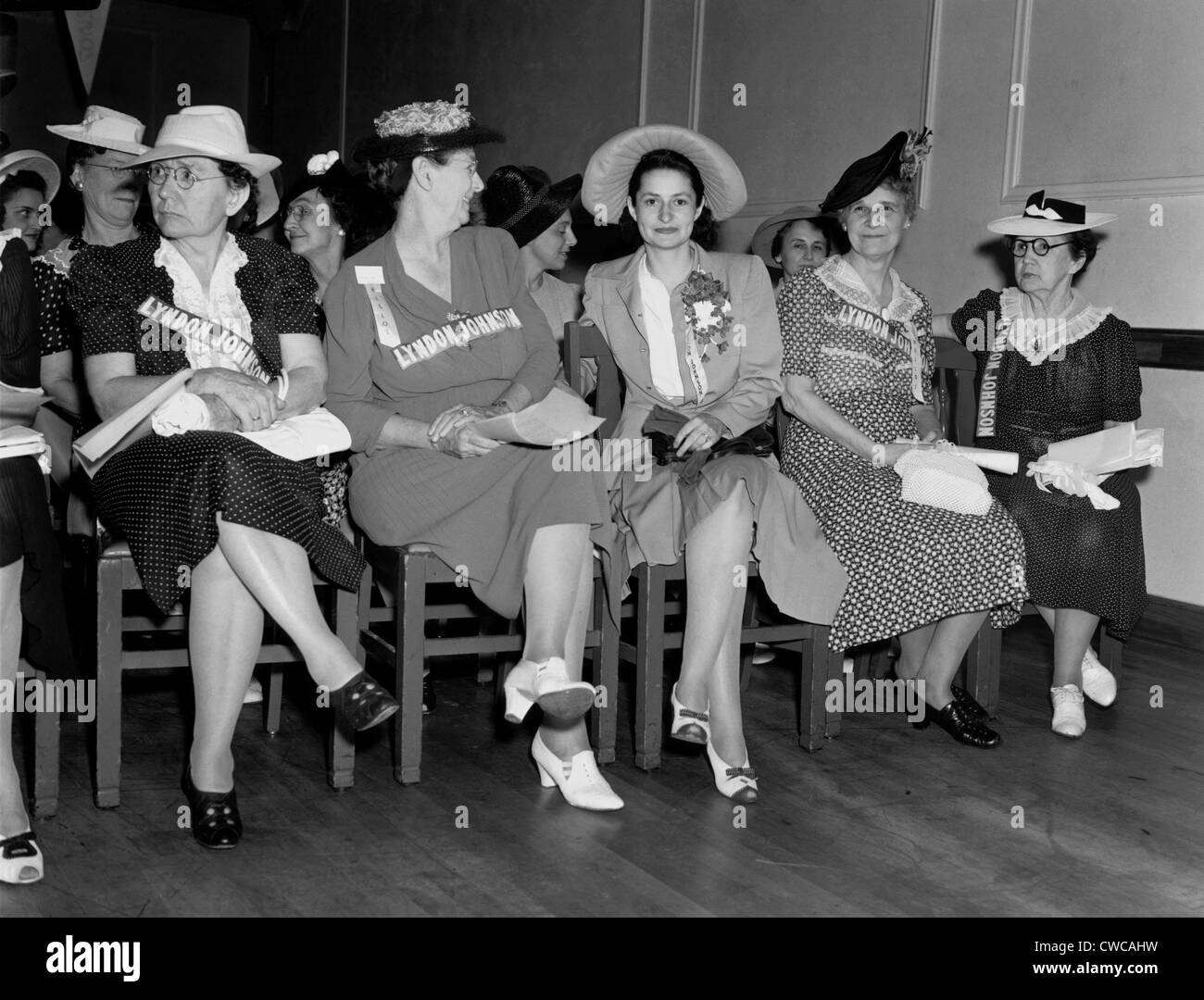 Lady Bird Johnson (3rd from left) sits with women at a campaign rally